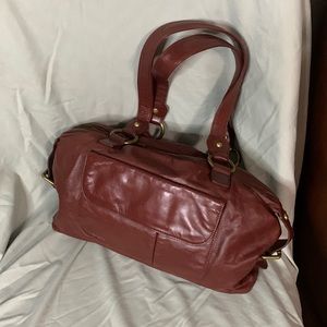 Soft supple leather outside with a world map-material inside. Outside pocket